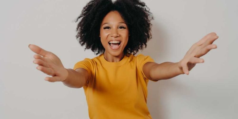 happy-see-you-studio-shot-young-overjoyed-african-lady-stretching-her-arms-wants-hug-smiling-cheerfully-camera-while-posing-isolated-white-background-dressed-yellow-tshirt